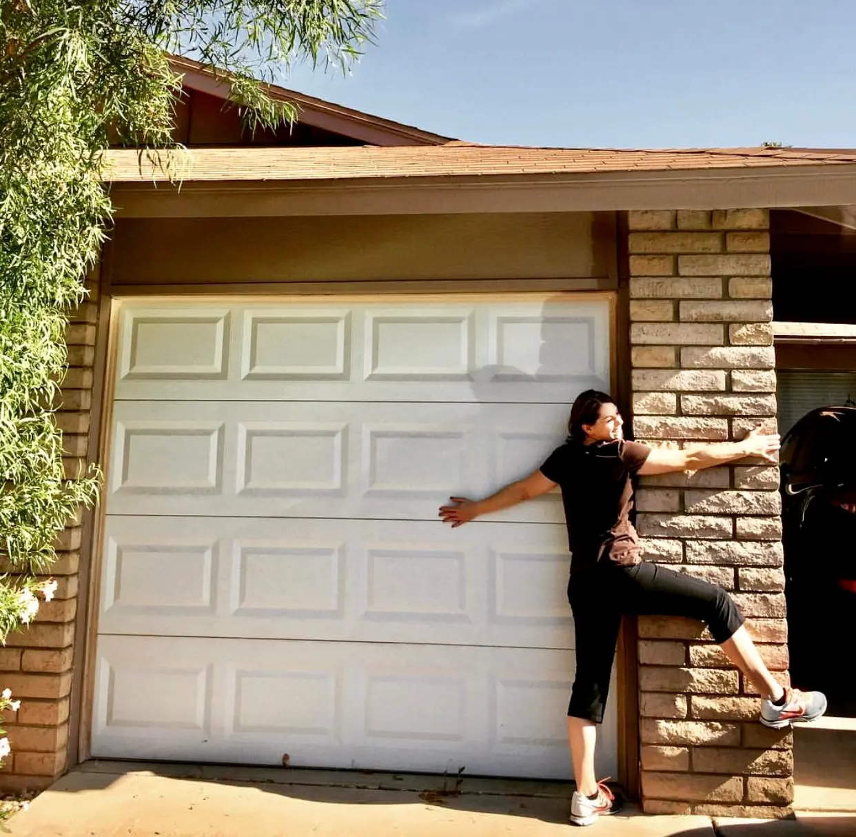 Andrea Scheppe hugging her first home in Dobson Ranch